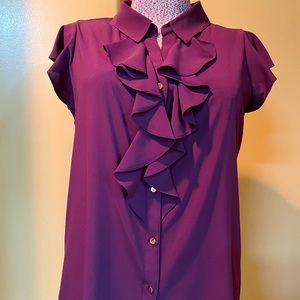 Calvin Klein sleeveless blouse looks great with a blazer or suit.